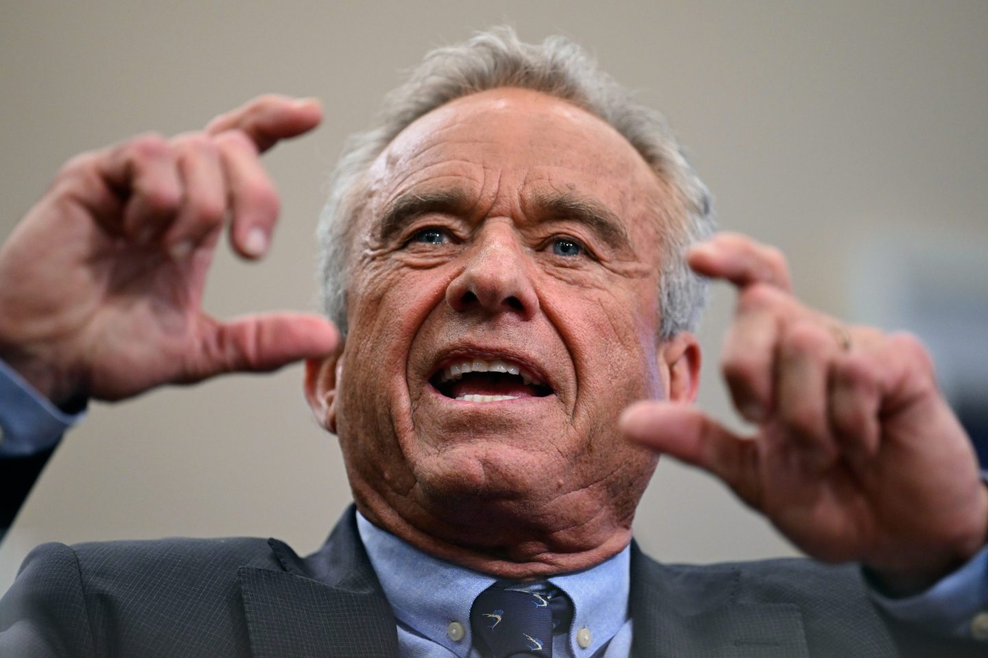RFK Jr. holding up his hands while appearing at a hearing